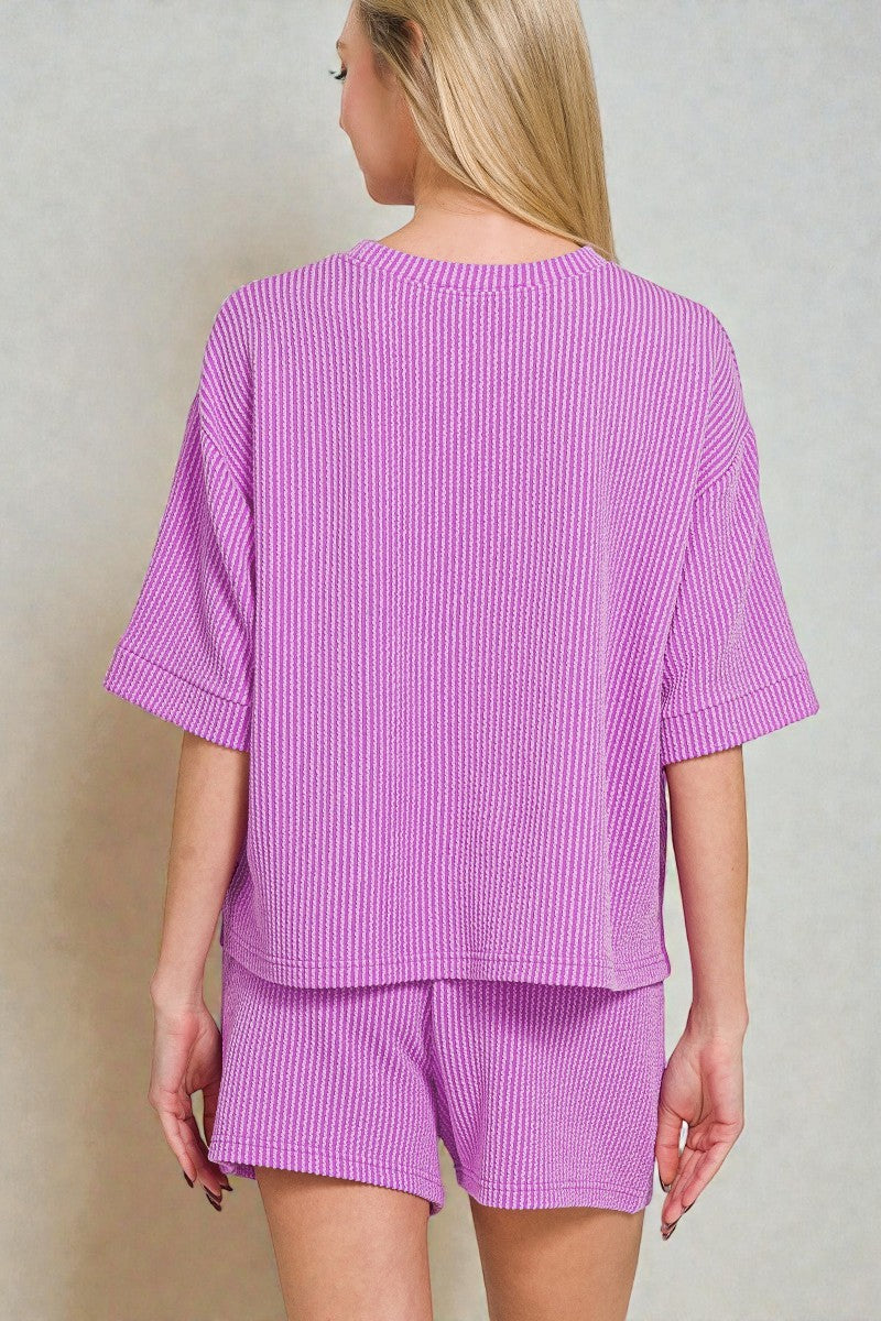 Person wearing a purple striped outfit on a plain background