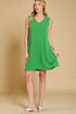 Woman wearing a green dress against a beige background