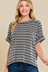 Woman wearing a black and white striped shirt against a beige background