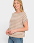 Woman wearing a beige and brown striped top against a white background