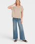 Woman wearing a striped shirt and blue jeans on a white background