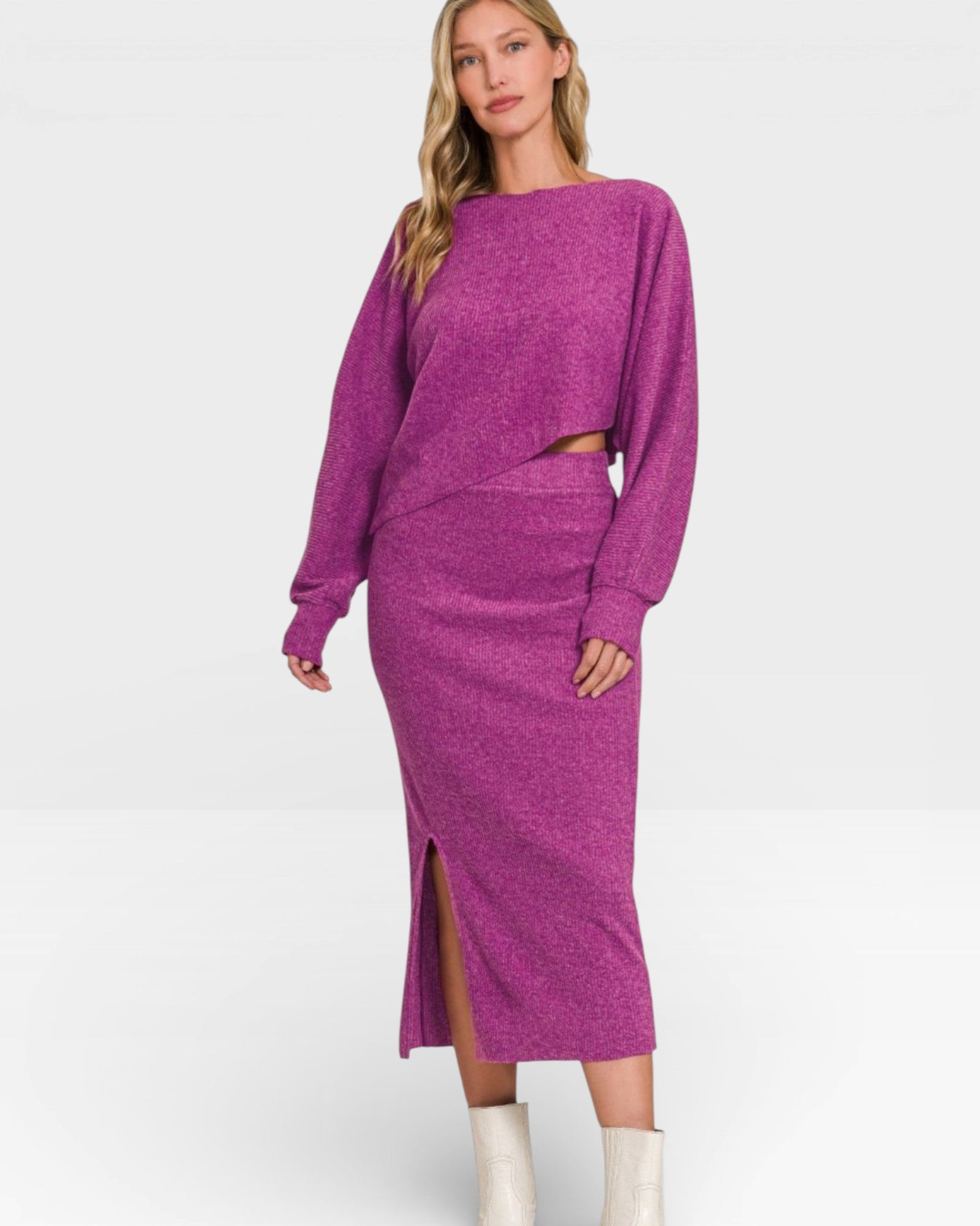 Woman wearing a purple sweater and skirt set on a white background