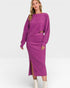 Woman wearing a purple sweater and skirt set on a white background