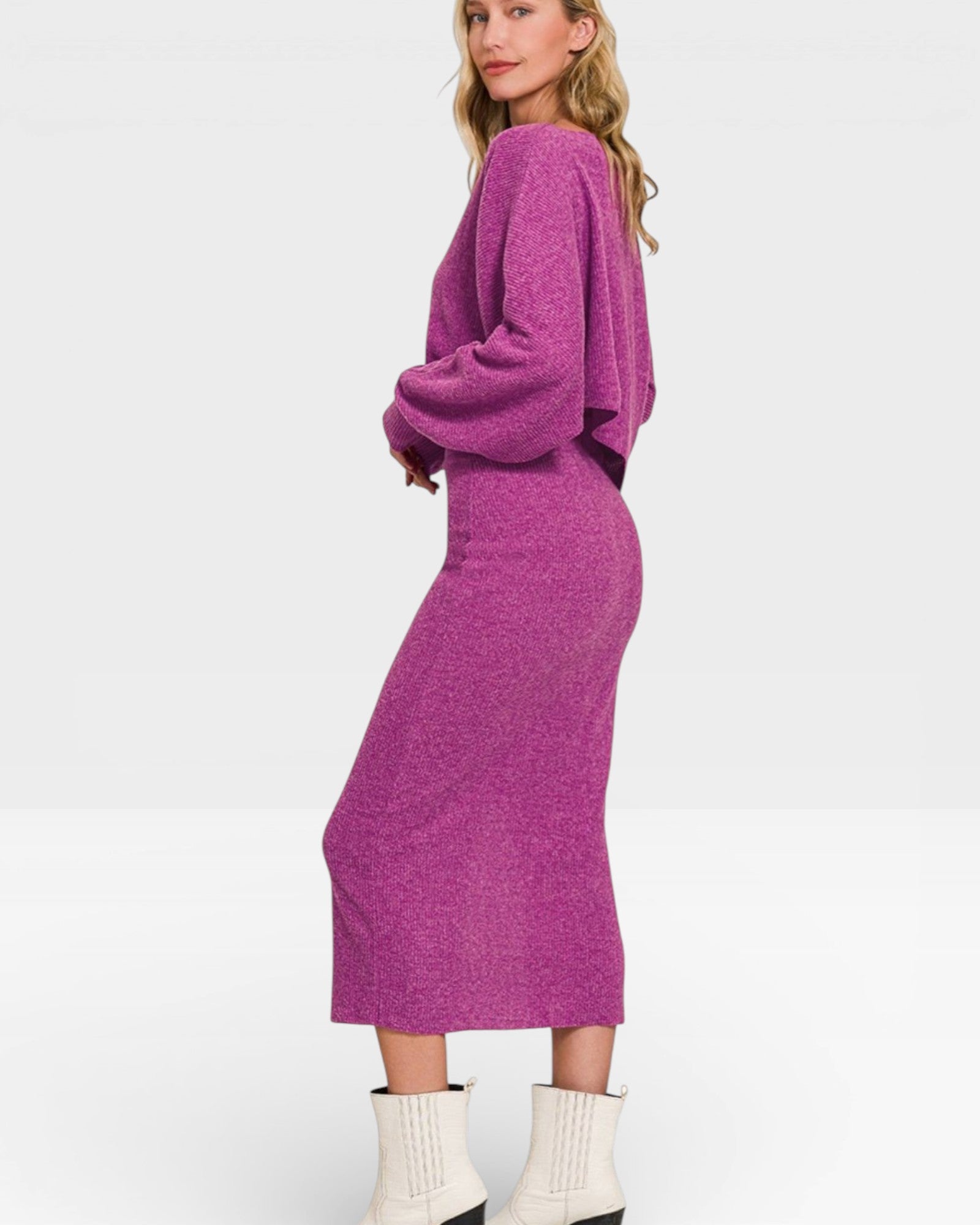 Woman wearing a purple dress with a plain background