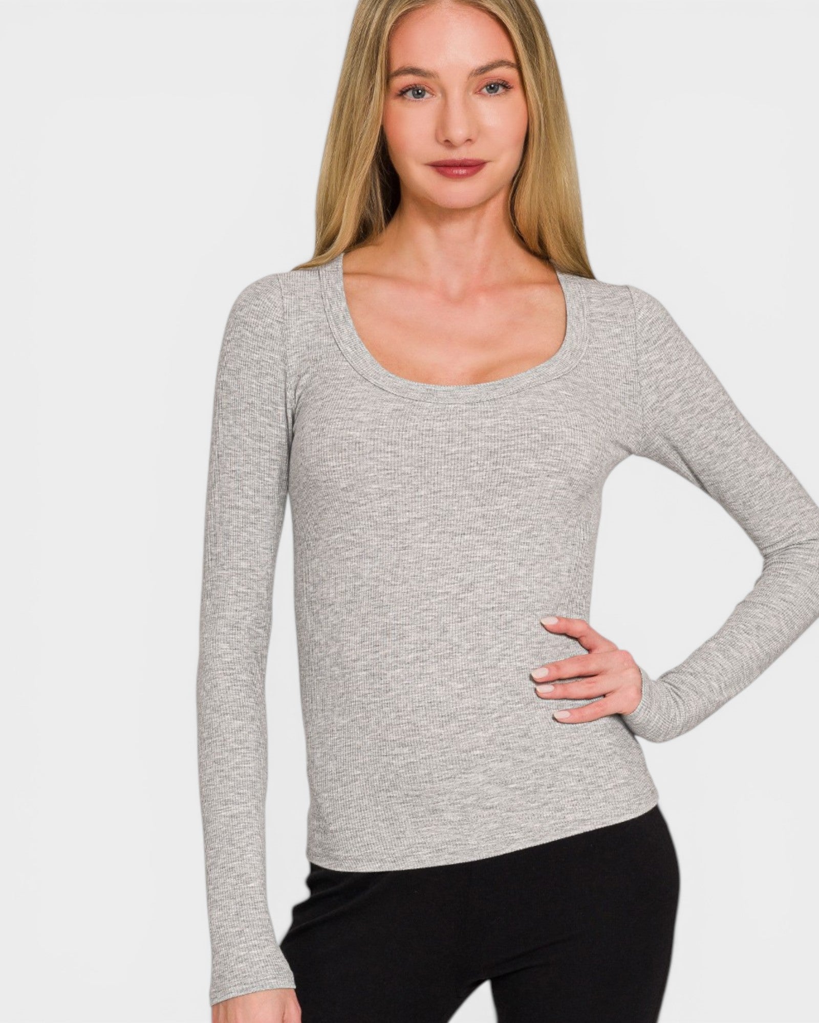 Woman wearing a gray long-sleeve top against a white background