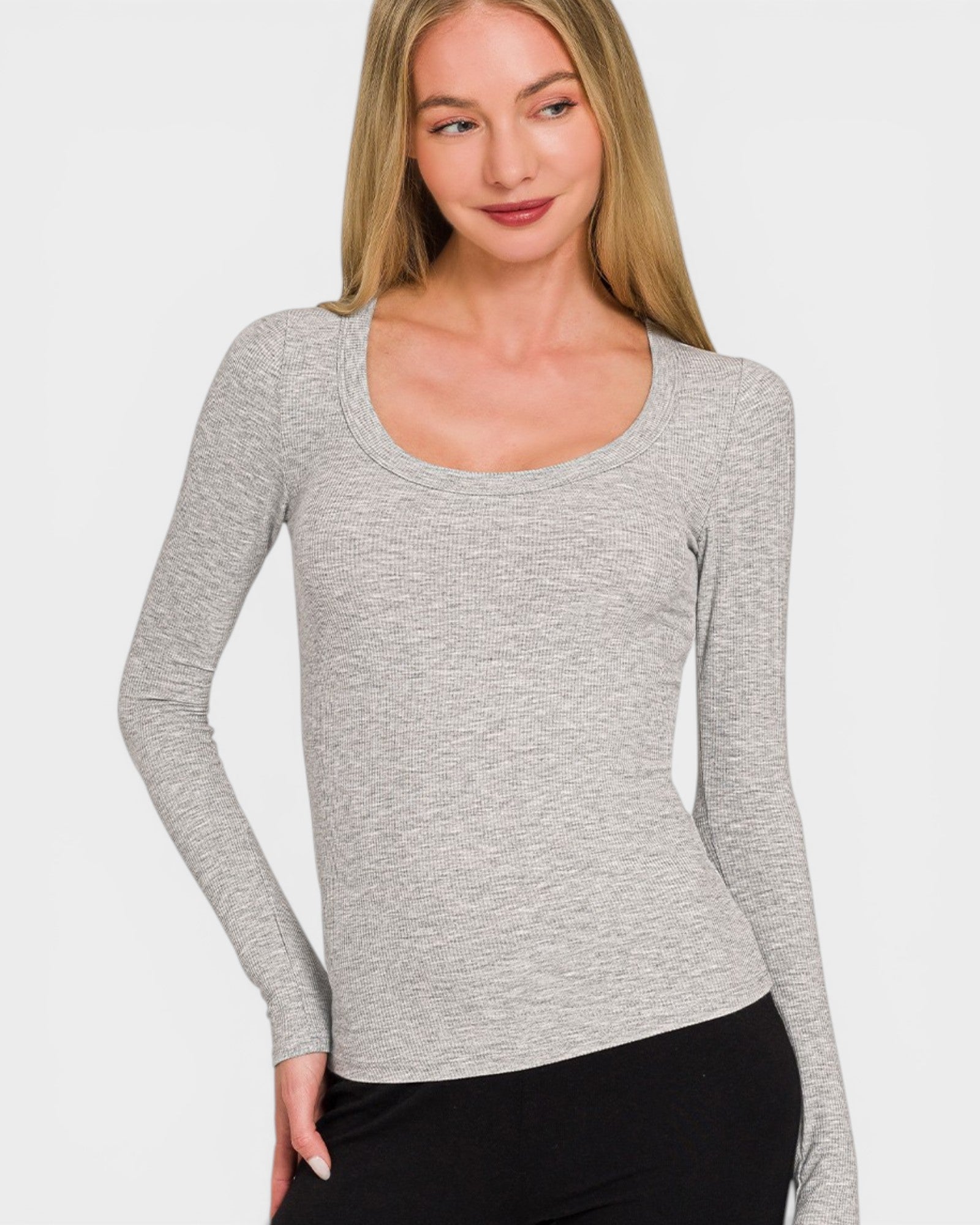 Woman wearing a gray long-sleeve top against a white background