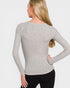 Woman wearing a gray long-sleeve top on a white background