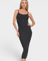 Woman wearing a black sleeveless dress on a white background