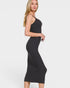 Woman wearing a black sleeveless dress on a white background