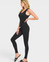 Woman wearing a black sleeveless jumpsuit on a white background