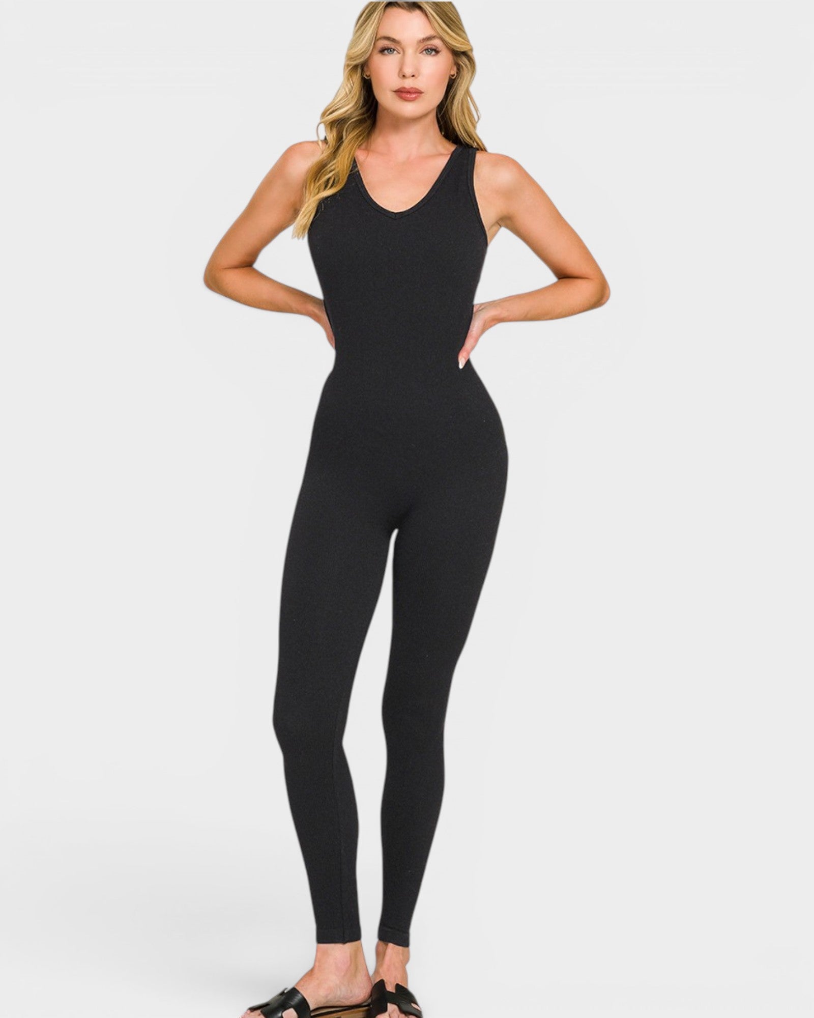 Woman wearing a black bodysuit on a white background