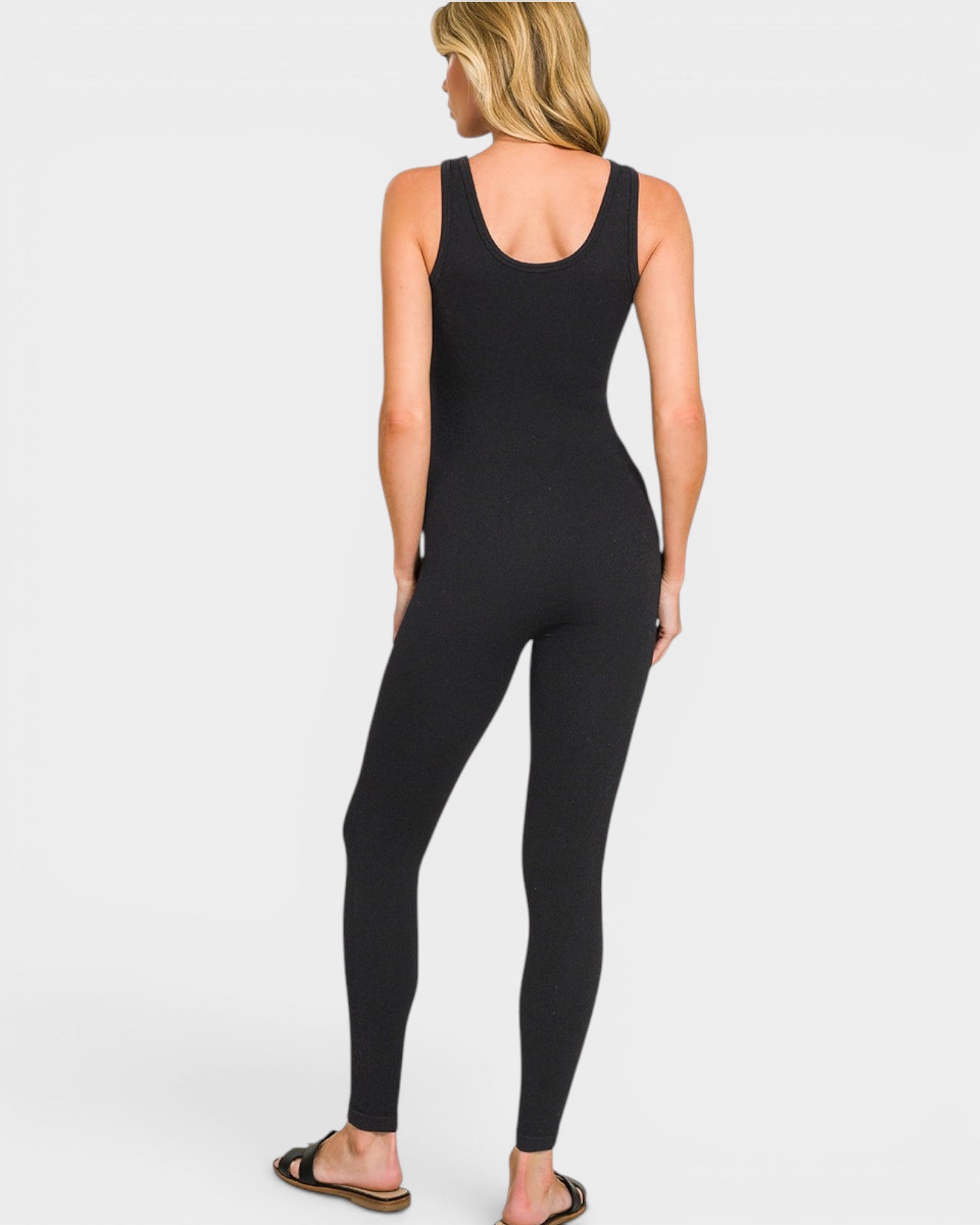 Person wearing a black jumpsuit on a white background