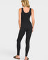 Person wearing a black jumpsuit on a white background