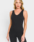 Woman wearing a black sleeveless bodysuit against a light gray background