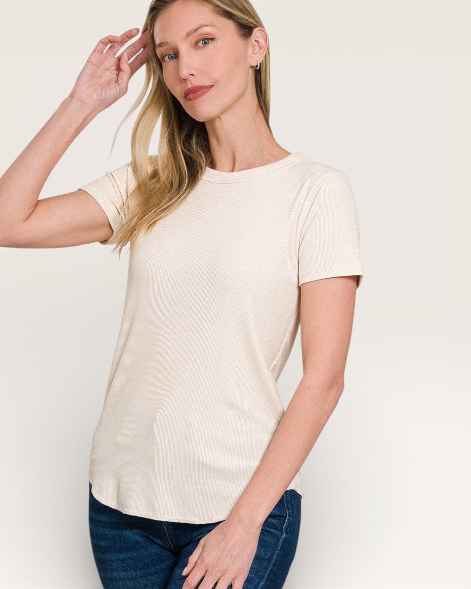 Woman wearing a plain white t-shirt against a light background