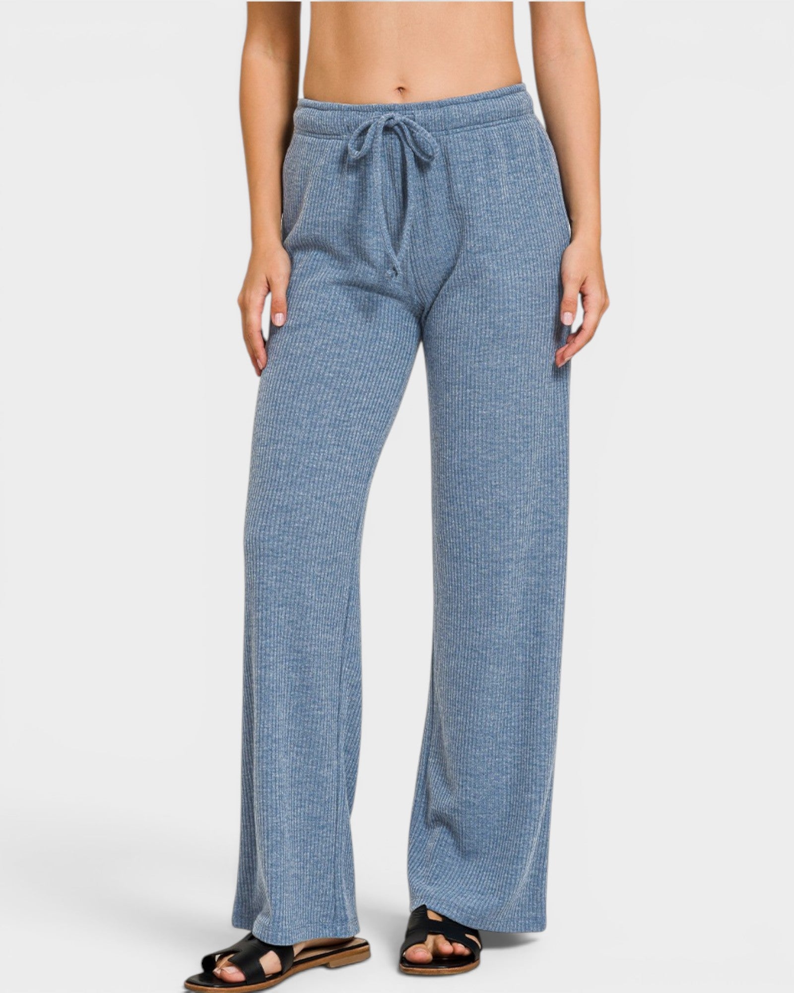 Blue checkered pants worn by a person on a white background