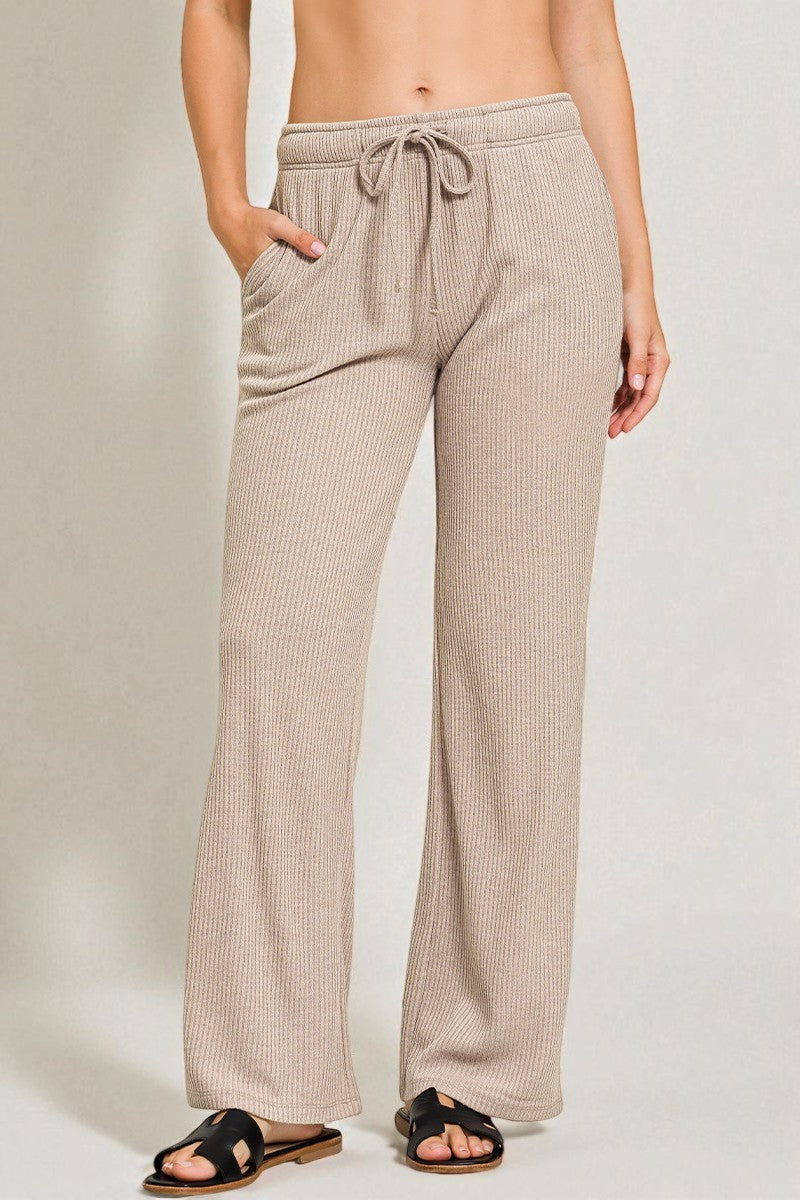 Beige checkered pants worn by a person on a plain background