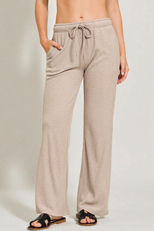 Beige checkered pants worn by a person on a plain background