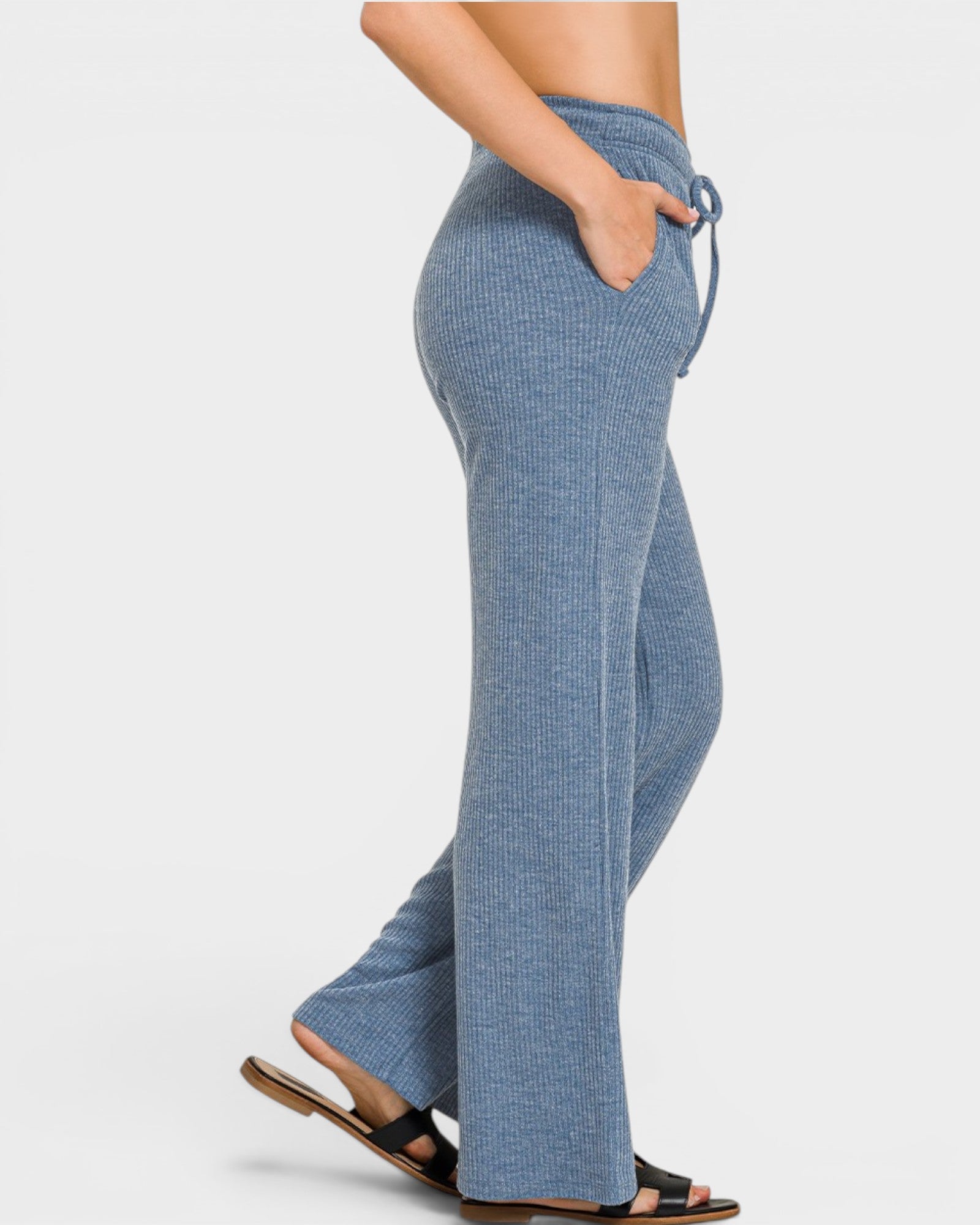 Blue checkered pants worn by a person on a light gray background