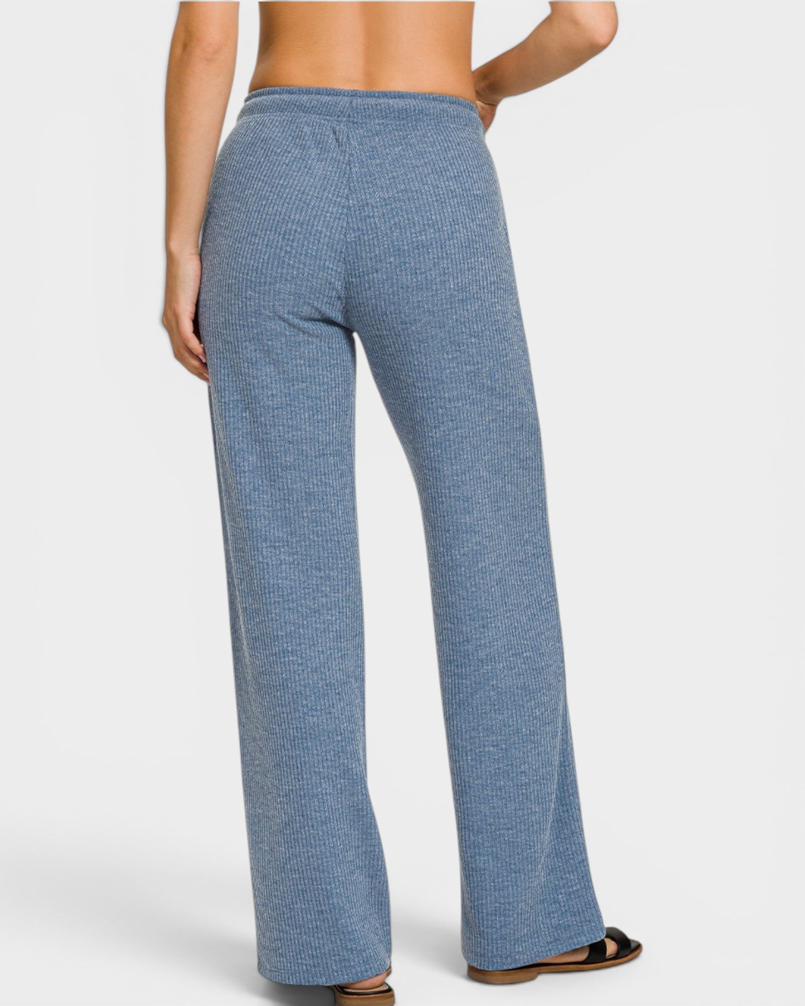 Blue checkered pants worn by a person on a white background