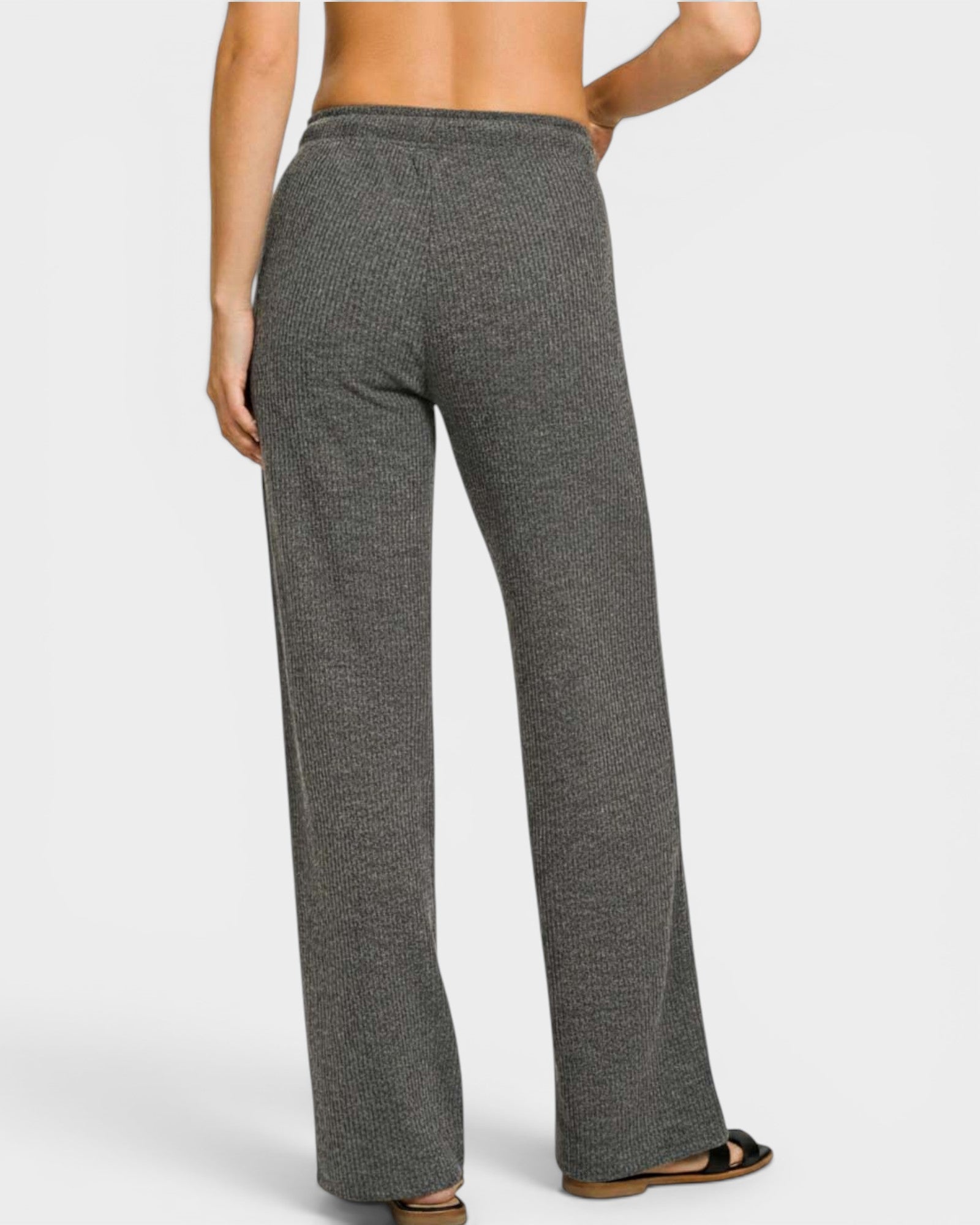 Gray patterned pants worn by a person on a white background