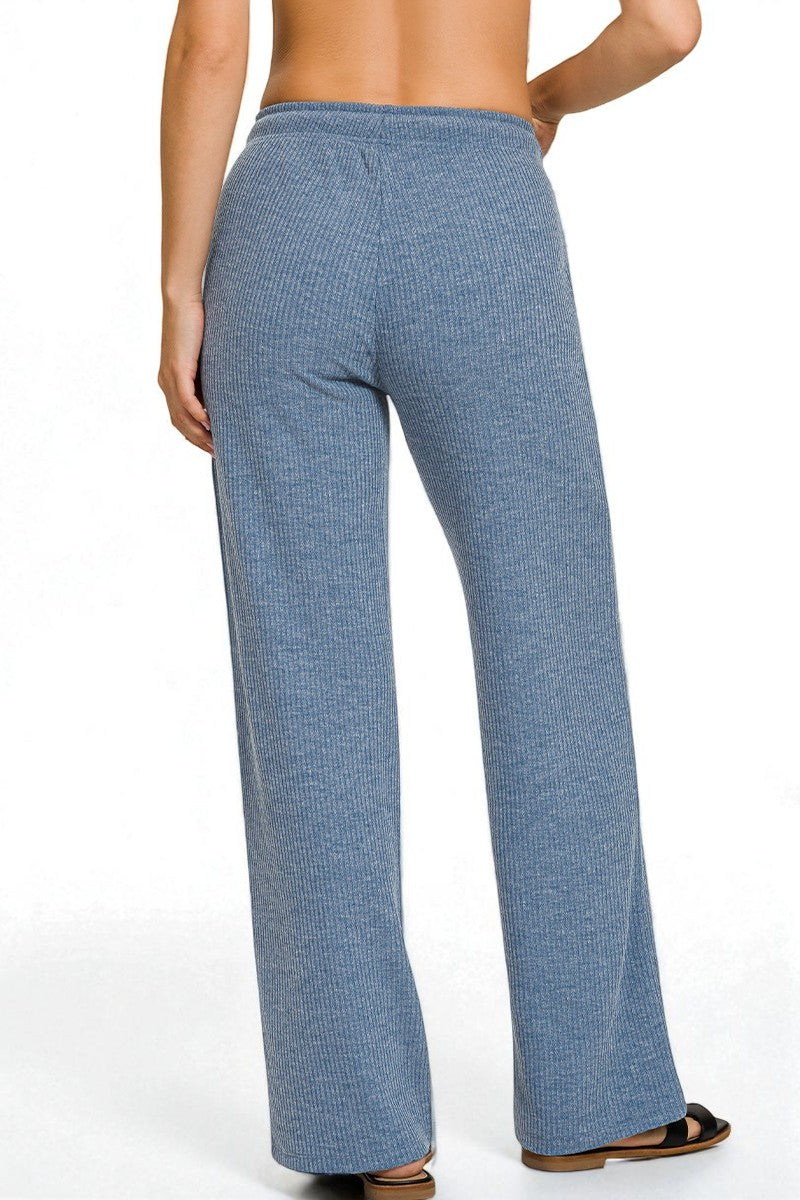 Blue patterned pants worn by a person on a white background