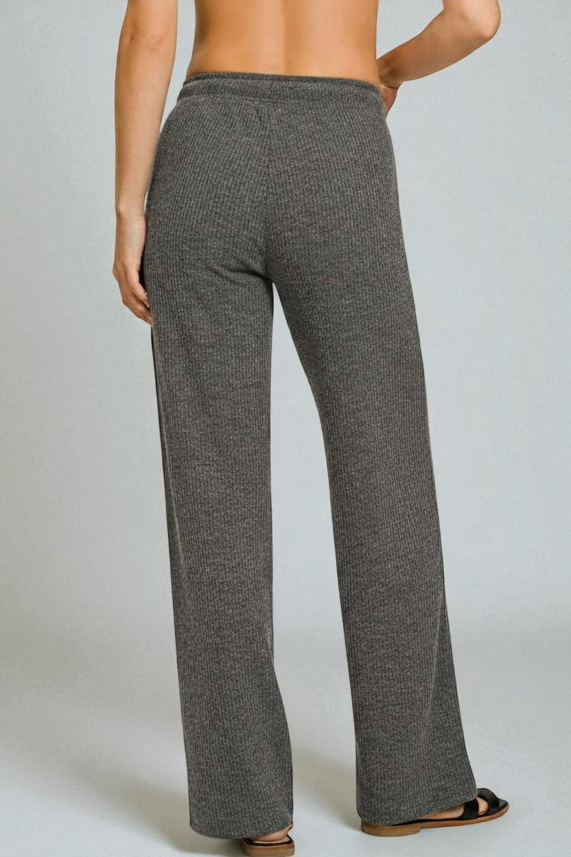 Gray textured pants worn by a person on a plain background