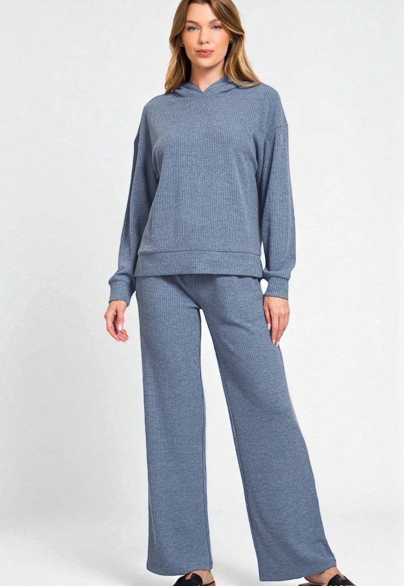 Woman wearing a blue loungewear set on a white background