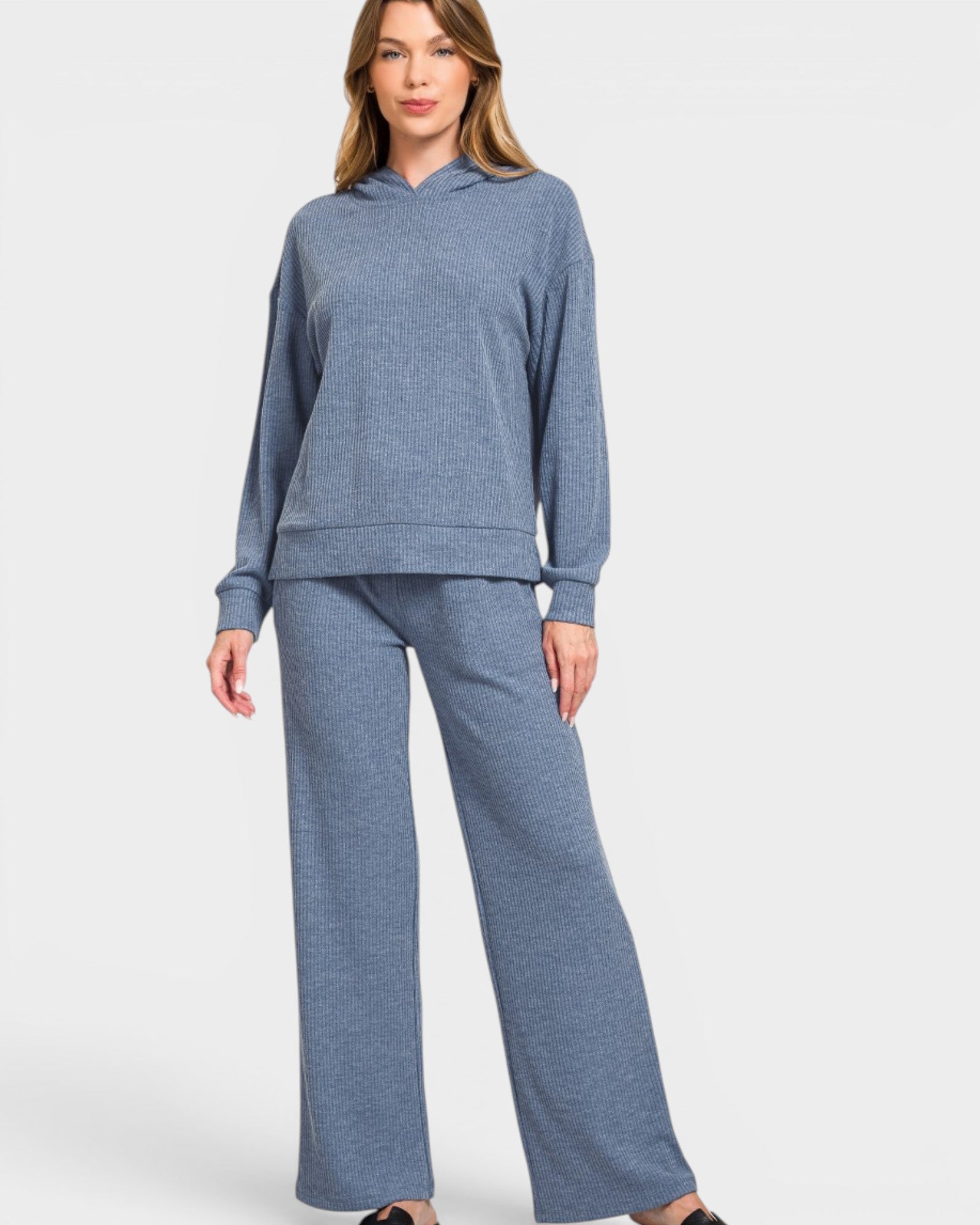 Woman wearing a blue tracksuit on a white background