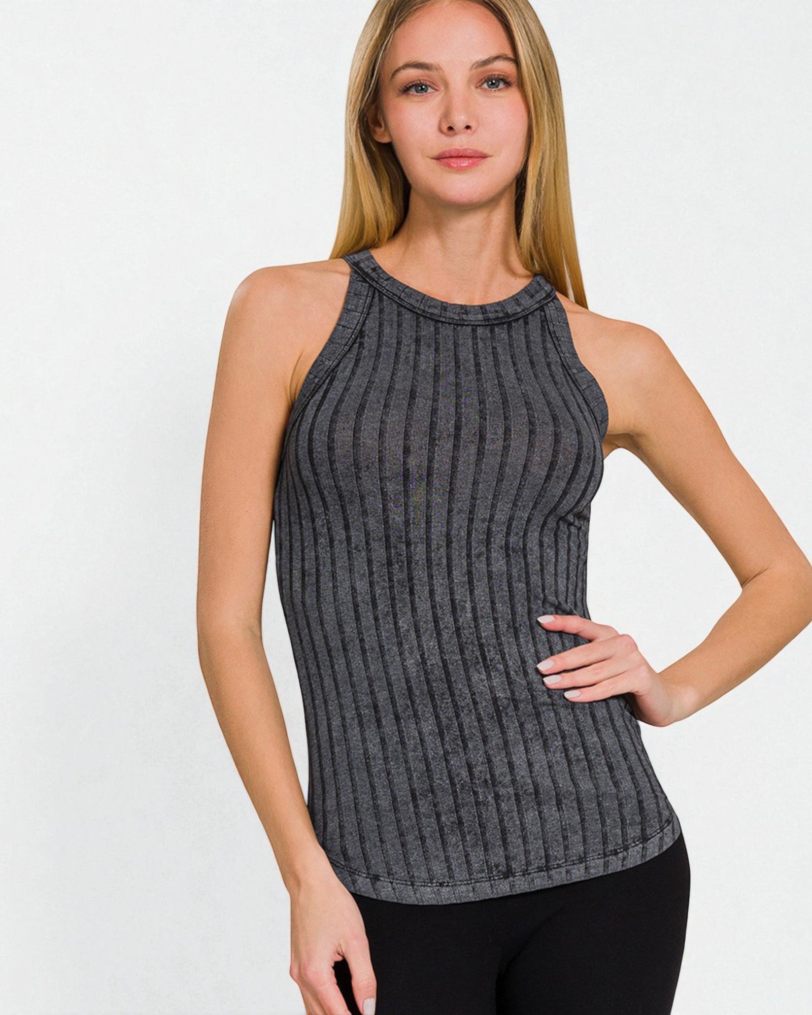 Woman wearing a ribbed gray tank top on a white background