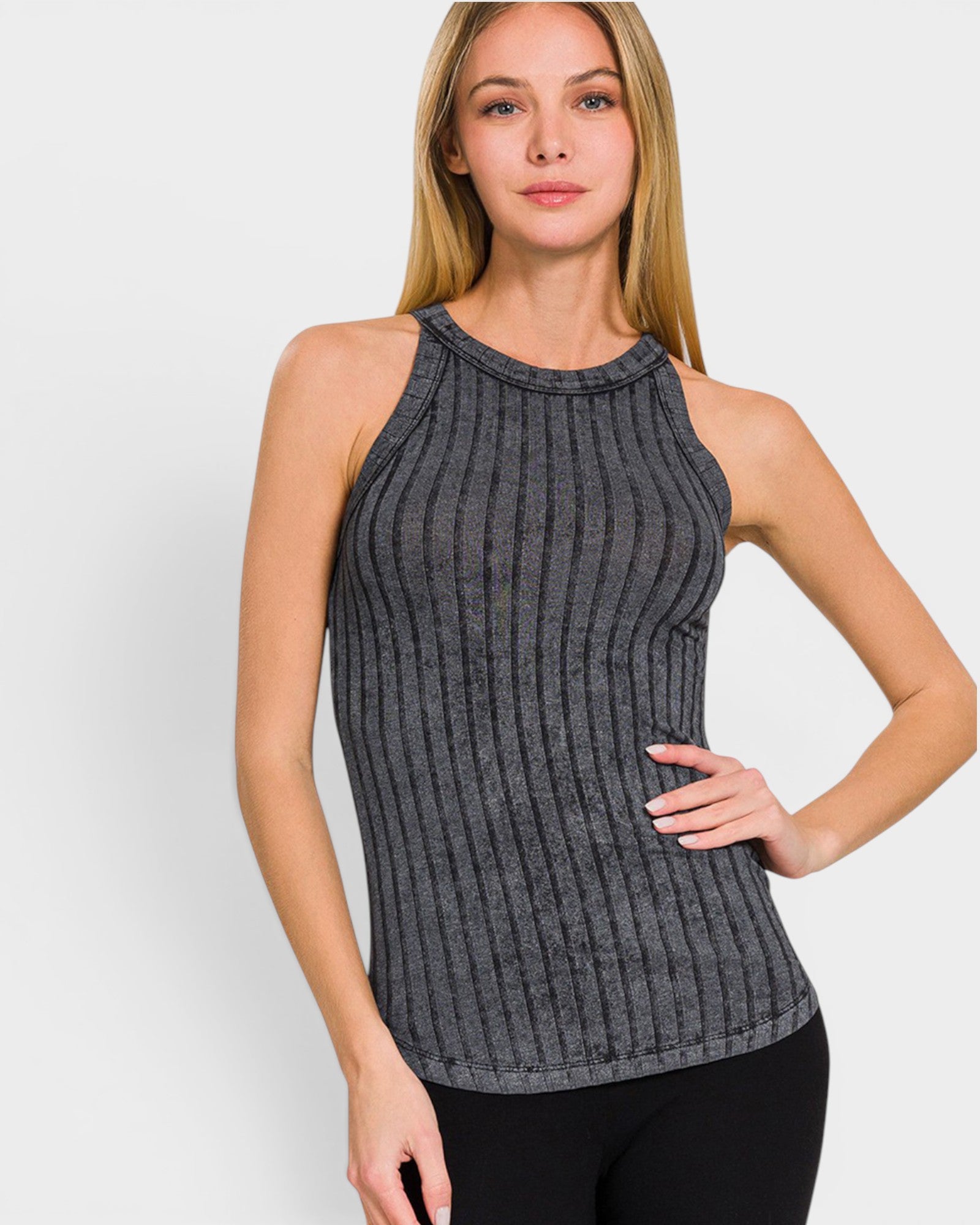 Woman wearing a ribbed gray tank top against a white background