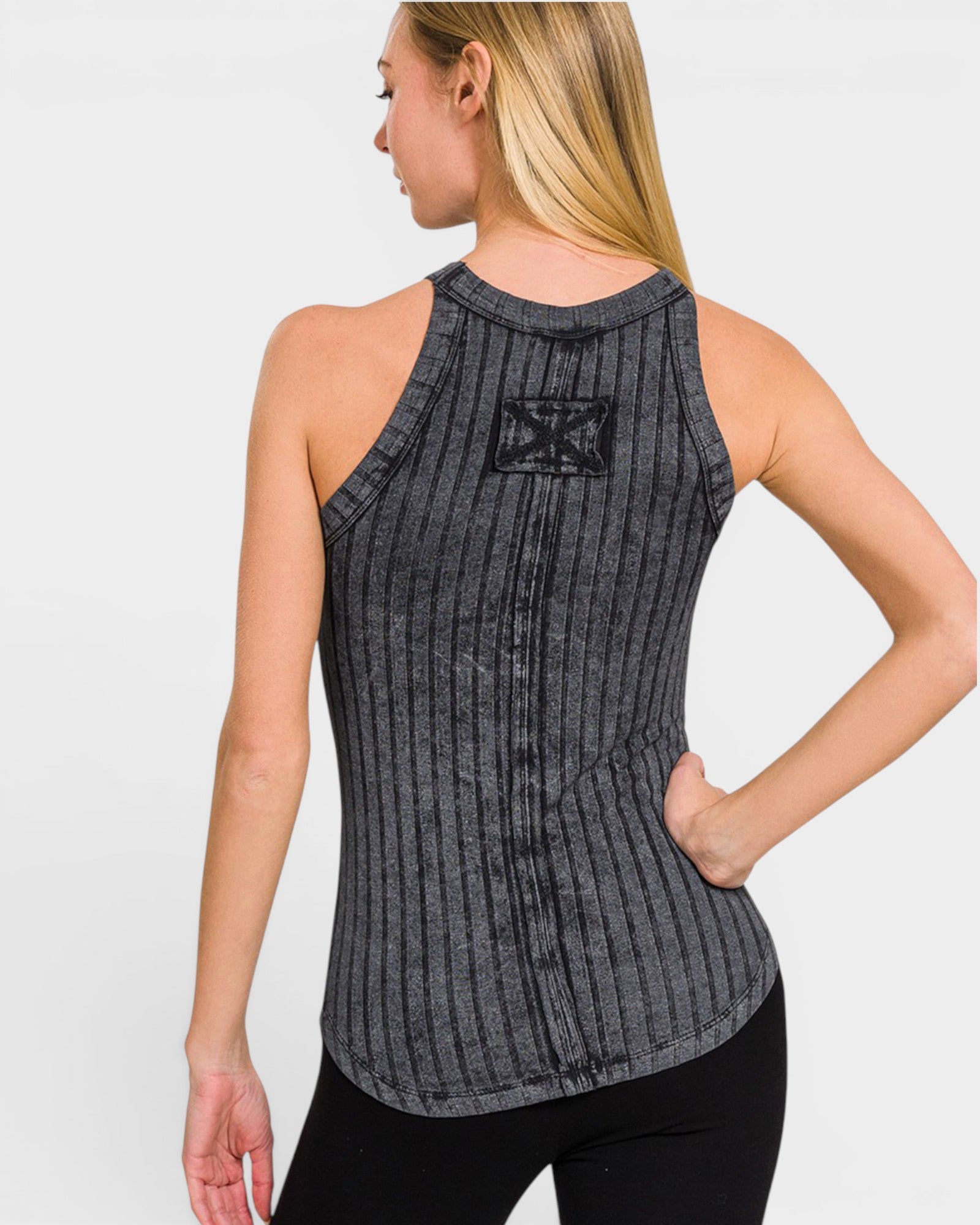 Woman wearing a gray ribbed tank top with a logo on a white background