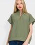 Woman wearing a green short-sleeve top with a zipper on a white background