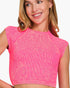 A woman wearing a bright pink ribbed crop top with cap sleeves and a high neckline, shown against a plain white background.