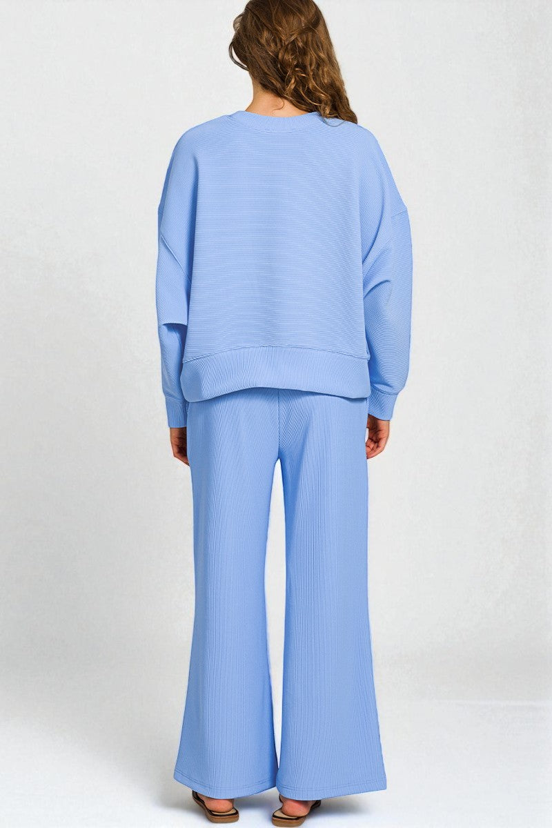 Light blue outfit with a top and wide-leg pants on a white background