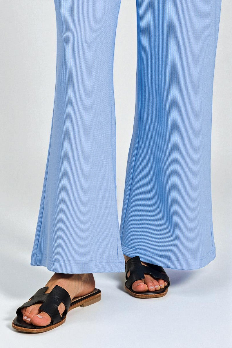 Light blue ribbed pants worn by a person on a white background