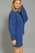 Woman wearing a blue outfit against a gray background