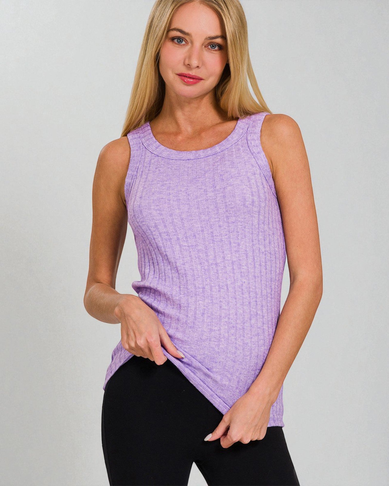 Woman wearing a purple sleeveless top against a gray background