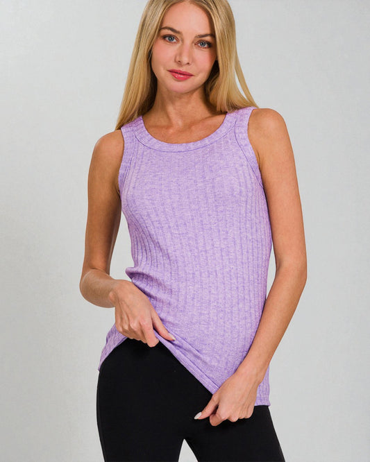 Woman wearing a purple sleeveless top against a gray background