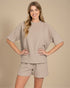 Woman wearing a beige outfit on a beige background