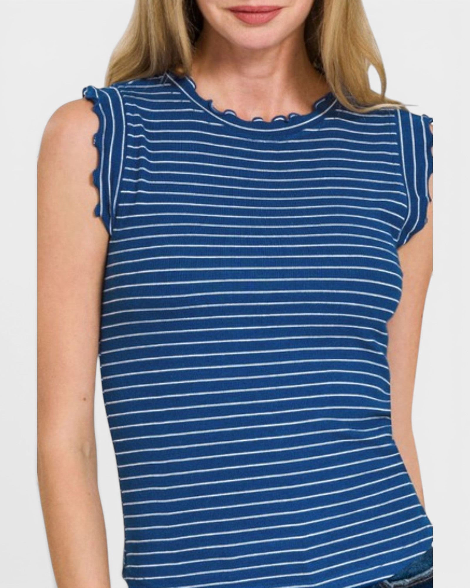 Woman wearing a blue and white striped sleeveless top on a plain background