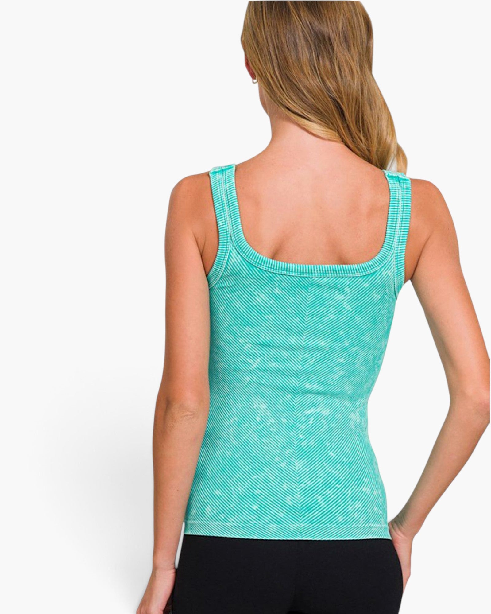 A woman shown from the back wearing a turquoise ribbed knit tank top and black pants against a plain white studio background.