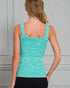 Woman wearing a teal tank top against a gray background