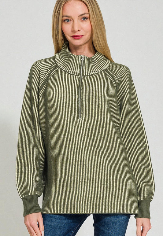 Woman wearing a green striped sweater against a plain background