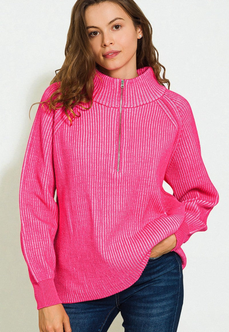 Woman wearing a bright pink long-sleeve top with a zipper on a white background