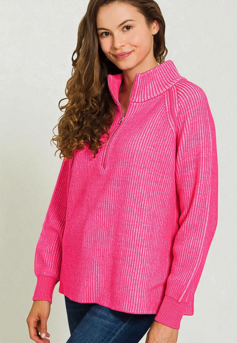Woman wearing a pink ribbed sweater with a white background