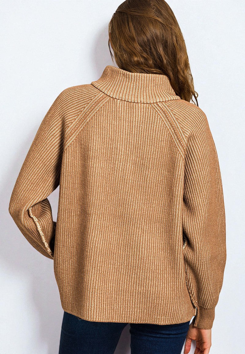 Person wearing a brown ribbed sweater on a white background