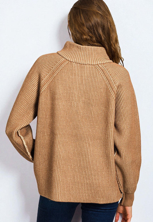 Person wearing a brown ribbed sweater on a white background
