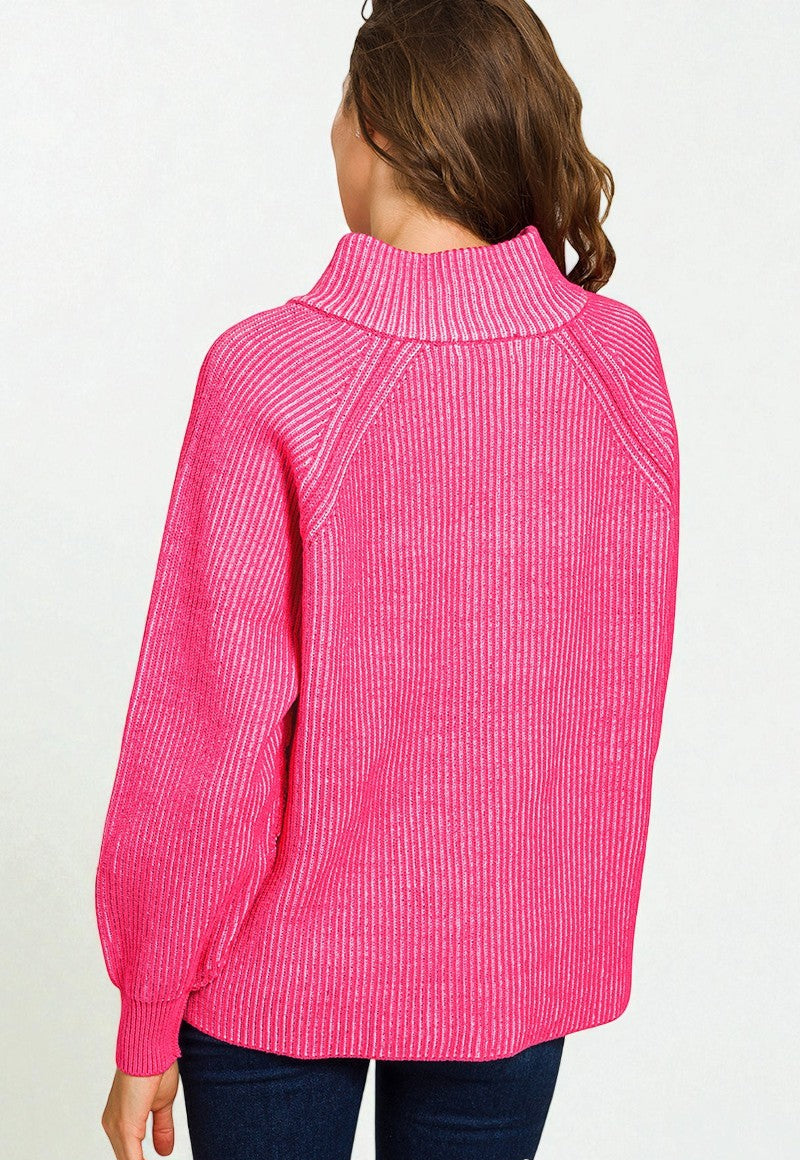 Person wearing a bright pink ribbed sweater on a white background