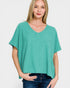Woman wearing a teal oversized sweater on a white background